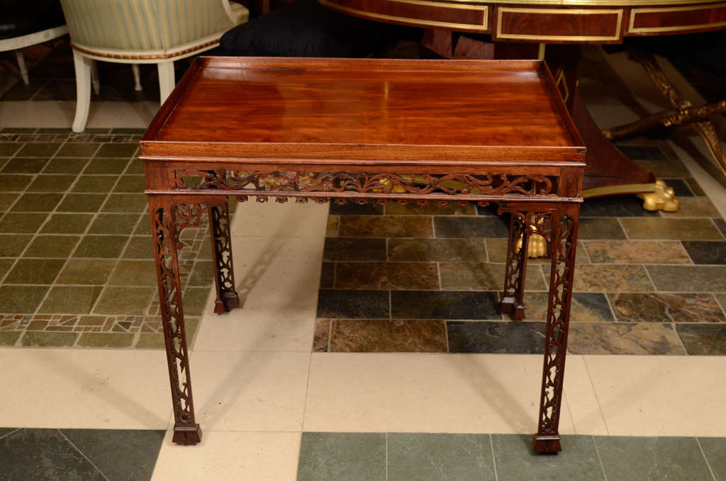 A fine George II mahogany open fretwork silver table with pierced fret
legs and raised on casters.