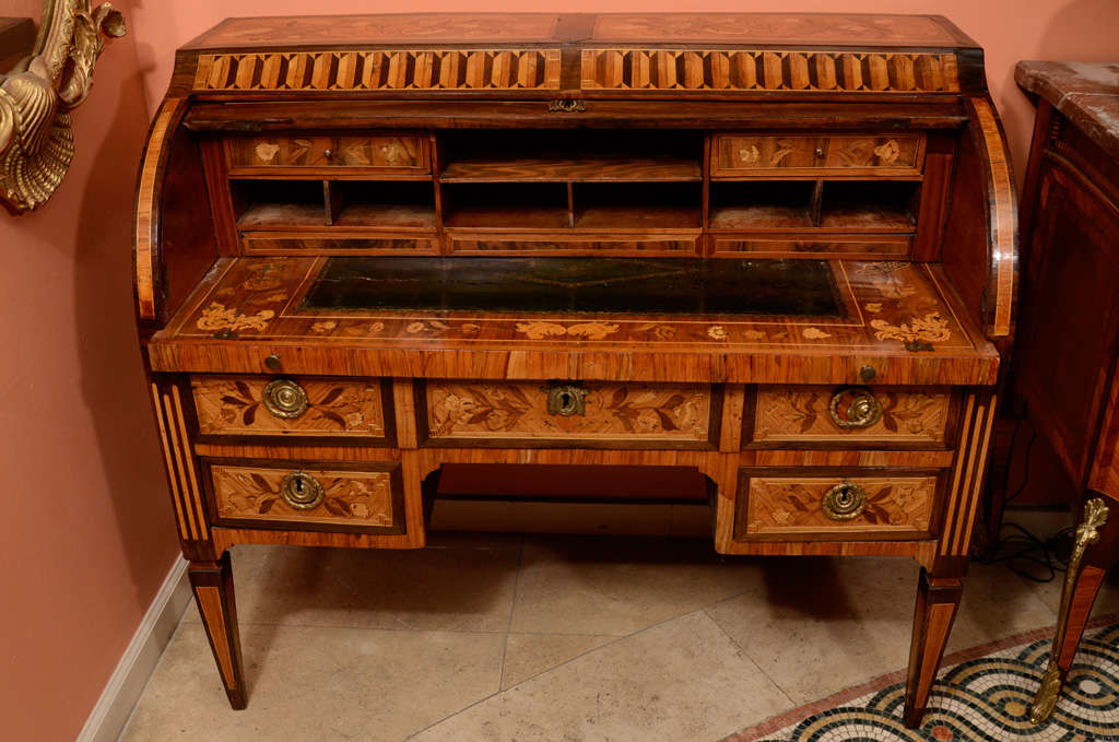 A fine Dutch Neo Classic marquetry inlaid roll top desk with leather top sliding writing surface and raised on square tapered legs.  