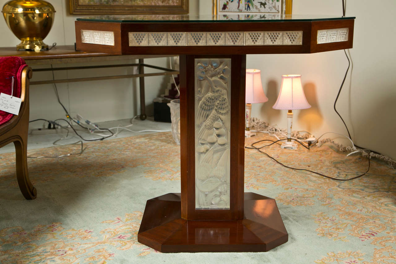 Signed Lalique pedestal table, four frosted panels surround the base of this stunning example of the art of glass-making Deco in style with highly polished wood surfaces.