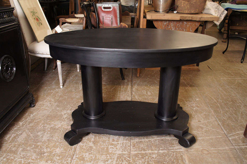 Black ebonized oval double pedestal table with drawer.  Great as center hall table.