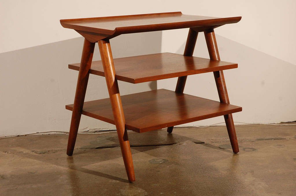 The inlaid brass crosses within the warm walnut tops of these 1960s side tables, combined with their elegant structural silhouette, makes these pieces especially distinctive. They are perfection next to a low Milo Baughman sofa or bedside with art