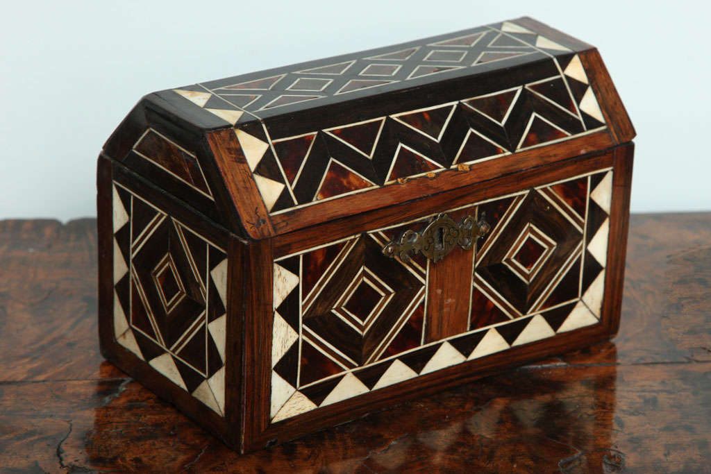 Unusual ebony, ivory, tortoiseshell and rosewood casket, Flemish, probably Antwerp, circa 1740, the top inlaid with diamond pattern, over zig zag over other geometric designs, the interior formerly with dividers, having original lock and hardware,