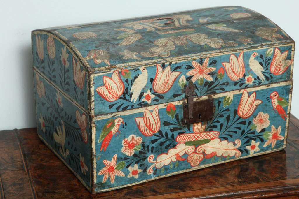 French, probably Rouen, painted marriage box, the top with parrots and tulips and a flowering urn and retaining original wire handle, the front and sides similarly decorated, the back in wonderful dry untouched surface, the whole with original