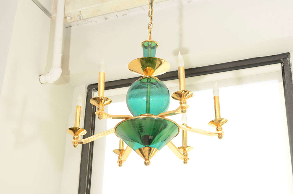 An Italian Turquoise Glass and Brass Six Arm Chandelier.