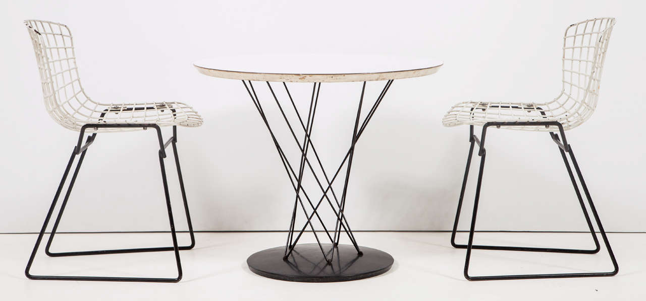 Early production, round white laminate top side table on black painted wire base.  Measures 20