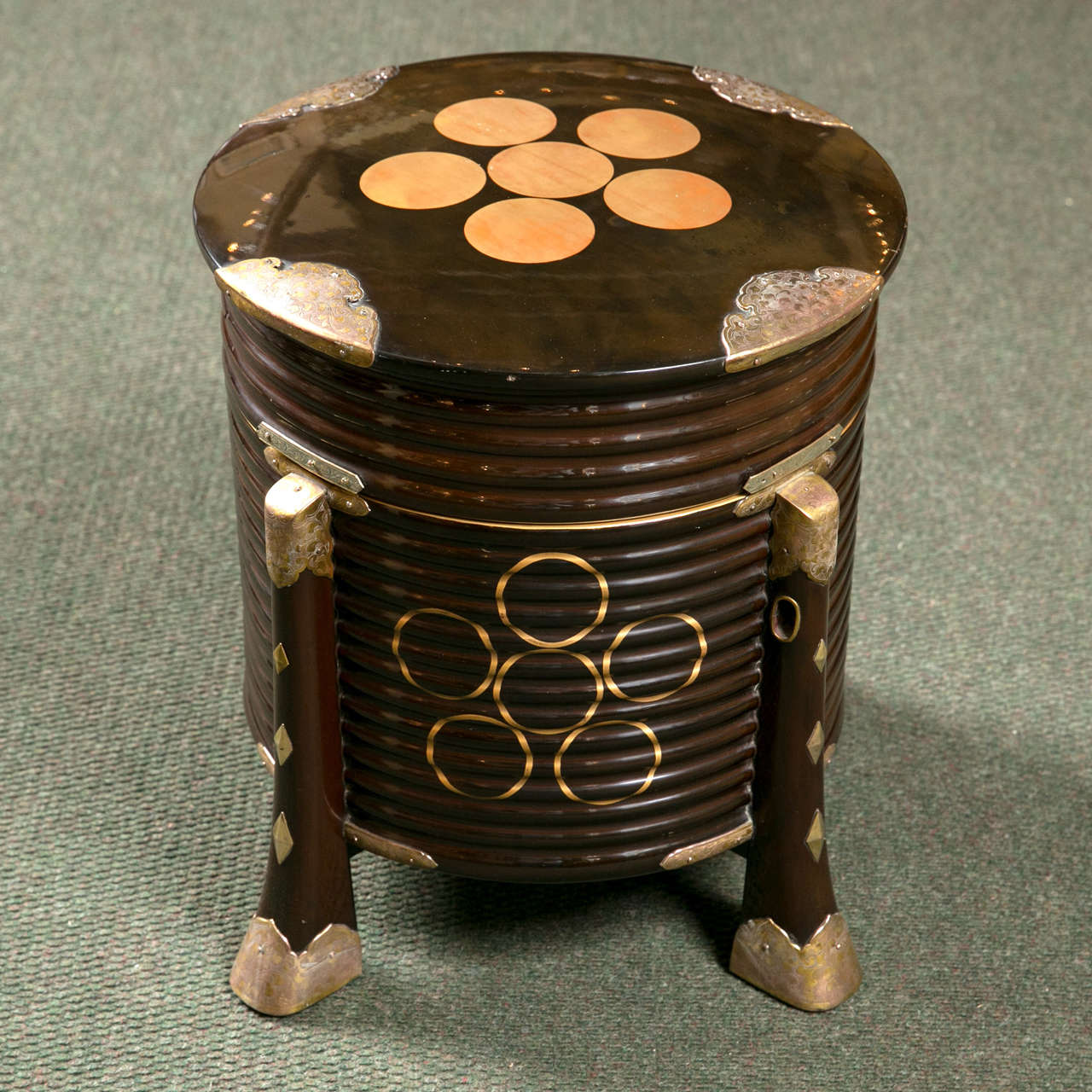 A Meiji period Japanese black lacquer hat box having decoration of pentagons of gilt circles and embossed brass trim.