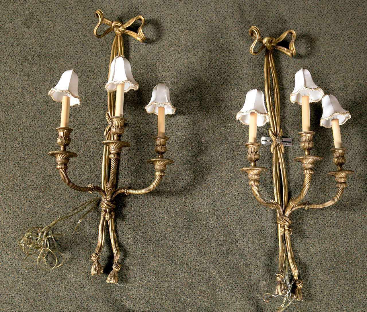 A wonderful pair of bronze three light, Edwardian bow and tassel sconces with mini shades.