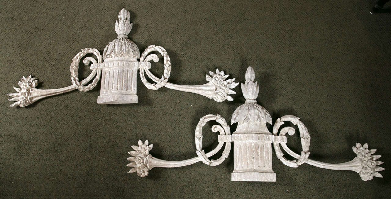 A pair of Italian urn and floral motif wall appliques.