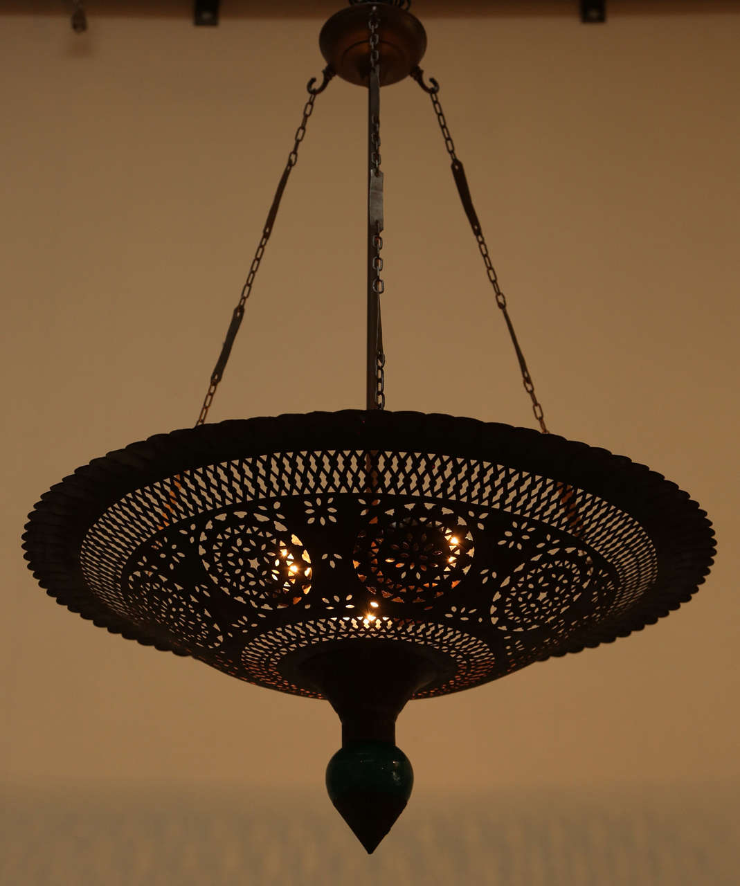 Moroccan hanging chandelier handmade with nice intricate geometric fretwork cut-out and a green ceramic porcelain final.
Rewire with three lights, ready to hang.

 Size is 43