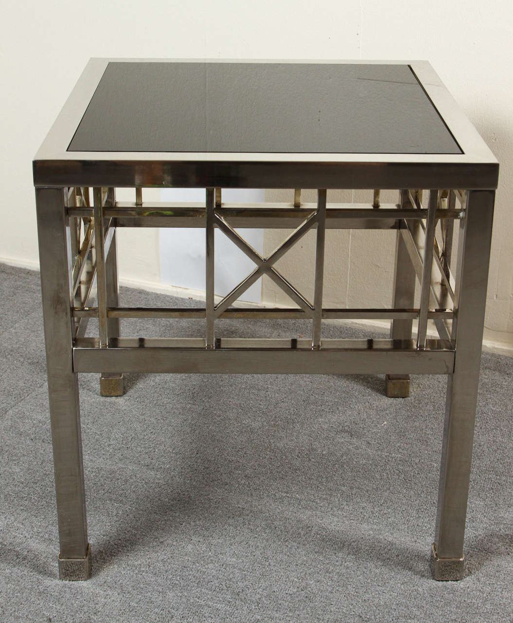 Pair of Campaign style side tables in nickel and brass with black glass inset in the top.
