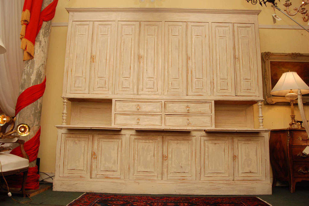 a over and under cabinet with adjustable shelving, with 3 pull out shelves for additional counter top. With 6 doors in the bottom section. In the center section are 4 drawers, and in keeping with the French, locks on all the compartments. It comes