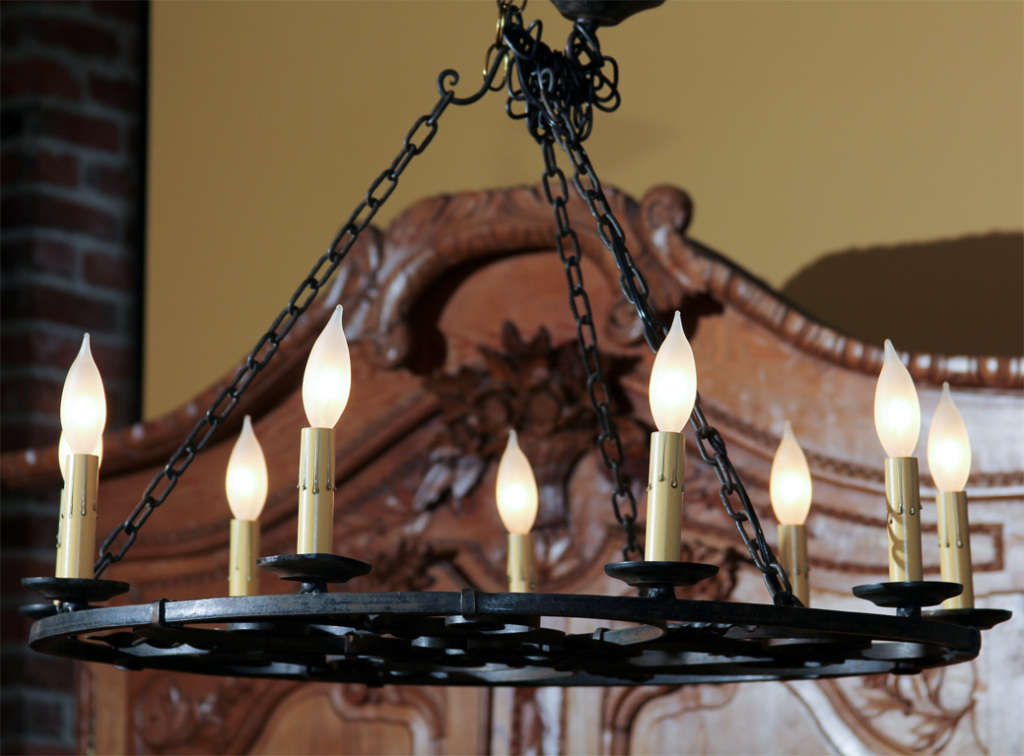 French Round Iron Chandelier

This unusual nine-light chandelier has wonderful heart and scroll iron design work.  

This chandelier was found in the Brittany area of France and needs to be rewired to US specifications.