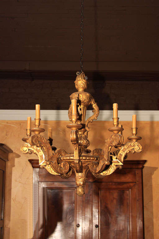French Napoleon III Gilt Chandelier

This is a great medium size gilt over carved wood (and gesso) chandelier. It is most unusual because it is wood underneath the gilt instead of metal.

It features 8 arms with candelabra style lights. The