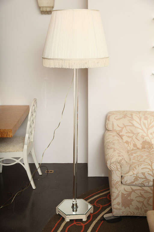 SYRIE MAUGHAM (1879-1955)<br />
Standing lamp with glass pole and mirrored hexagonal base <br />
with custom-made shade edged in fringe. English, c. 1935<br />
<br />
PROVENANCE<br />
Helen and George Hay Whigham residence, 48 Upper Grosvenor
