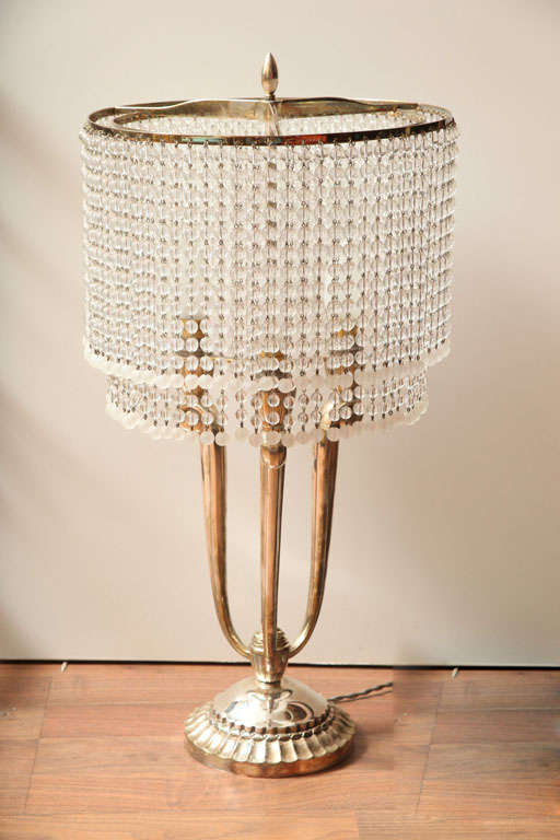 CAPON<br />
French Art Deco Table Lamp with silvered bronze base supporting rows of glass beads<br />
H. 23.6” (60 cm), D. 11.4” (29 cm)