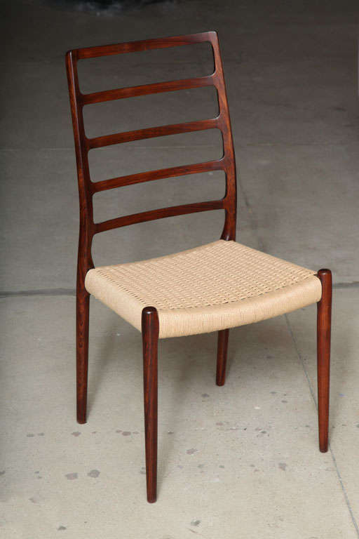 Vintage 1960s Niels Moller NO. 82 Rosewood Dining Chairs. Set of 10.

Stunning set of 10 Vintage Dining Chairs are solid rosewood high back ladder back dining chairs with papercord seats by Niels Moller.