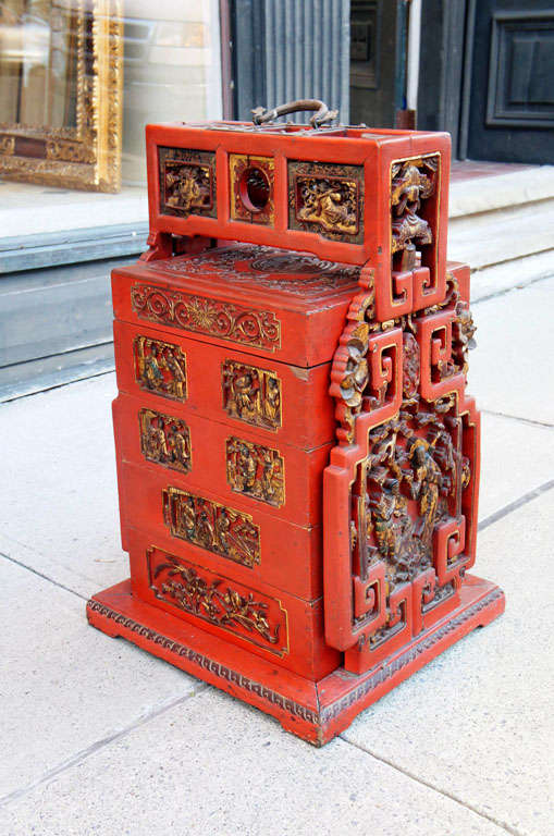 This large and impressive Mandarin food storage box is very detailed and well-constructed. The case, made of finely carved wood, houses five different stackable storage boxes. Each box is fronted on two sides with recessed carved panels that are