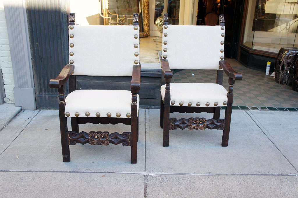 This fine pair of chairs Spanish in form and origin are mostly of the period but have some repairs/replacements to the legs and back. The form is nicely carved and constructed in the manner of mortis and peg and retains an old but very good finish. 