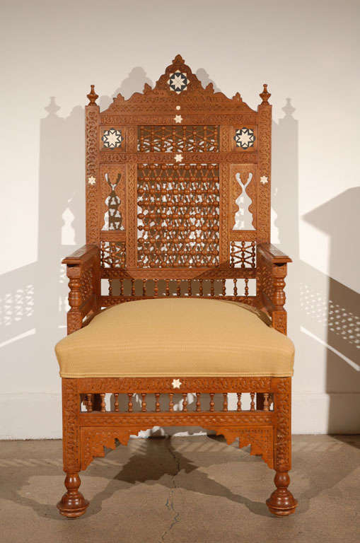 Large-scale Syrian Moorish armchairs, Middle Eastern  Arabian Syrian style, finely hand-carved and inlaid with bone and ebony.
Nice moucharabie designs all-over the chair, newly upholstered with gold Moroccan fabric.
Very Fine craftsmanship in Carlo