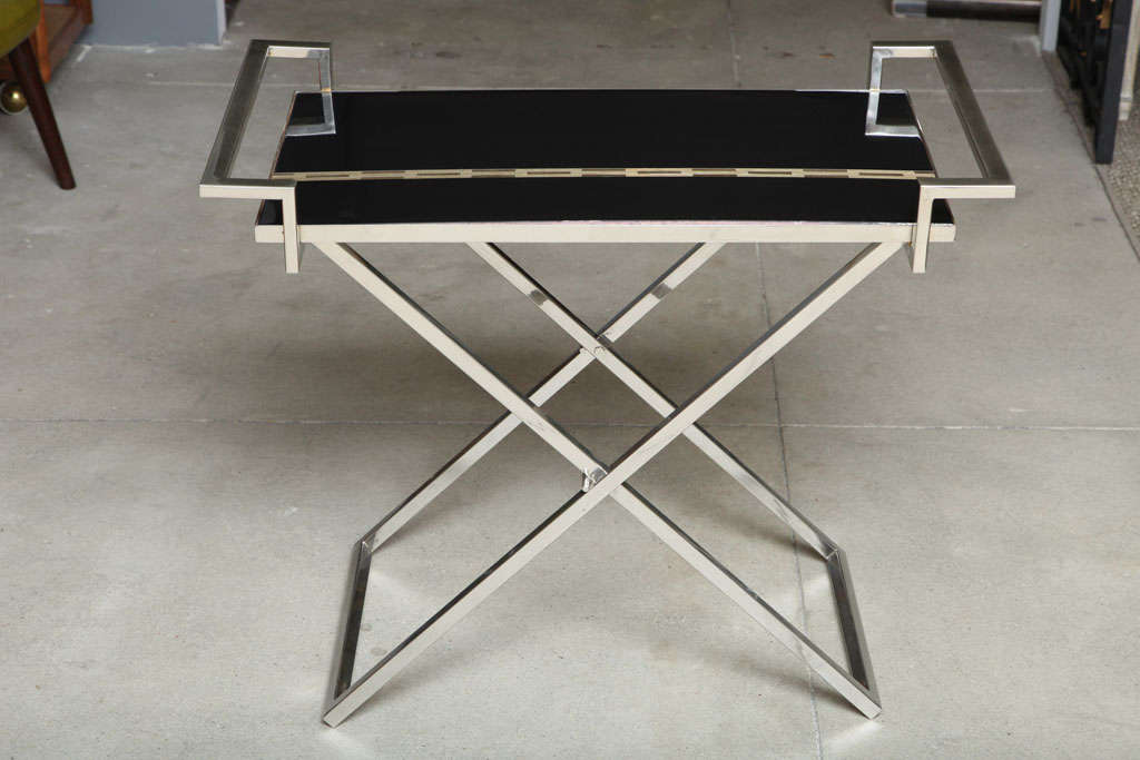 A very sleek and stylish black lacquered tray with inlaid brass design on a polished nickel stand.  This piece would make a perfect bar.