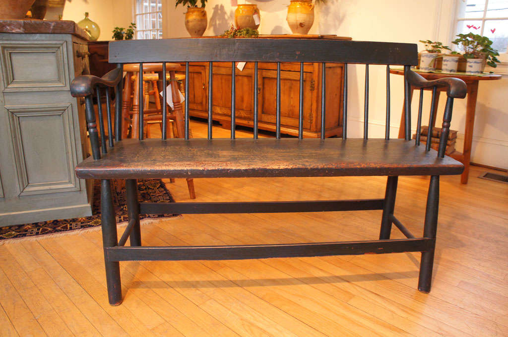 This sweet Canadian bench has a spindle back and nice old dark blue/green paint. it is a small size , perfect for a mud room or would work table side. it is very sturdy. it also has very, very nice wear on the bench. Its a beauty!