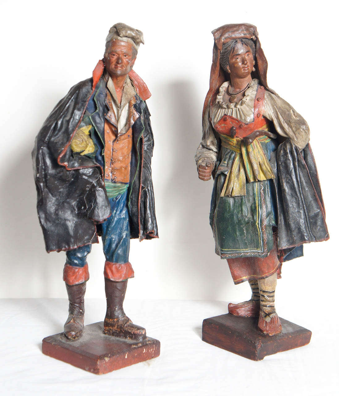 This pair of figures made from wood and varnished paper and fabric are nice examples of the decorative objects made to sell to tourists on a grand tour in the 19th century. Representing the bucolic feeling of Italy's country people the pair a man