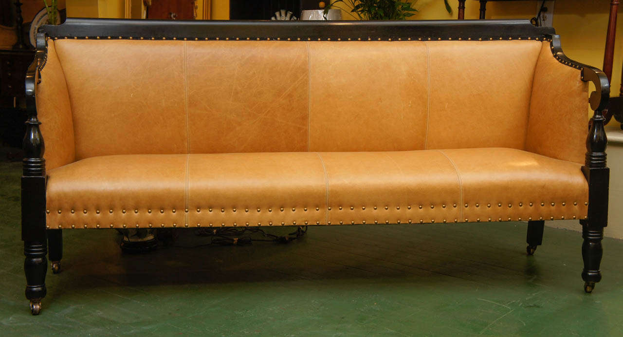 This Mohawk River Valley sofa or bench was made circa 1825. Refreshed for today's interiors the sofa or bench has a comfortable  seat which has been reupholstered in a soft tan leather with all new foundation material. The frame is ebonized giving 