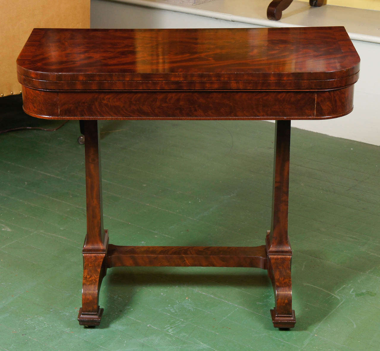 This fine period New York City card table was made by Duncan Phyfe in or a round 1830. This master craftsmen of the city was one of the most stylish and important cabinet makers of the time. This exquisite card table is made in what is called the