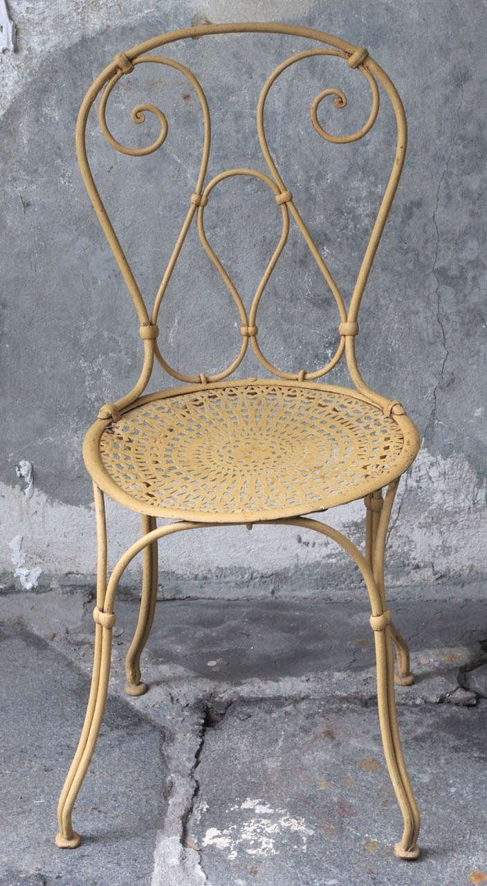Set of six late 19th century French painted iron garden chairs with perforated seats, Vichy model, circa 1890.