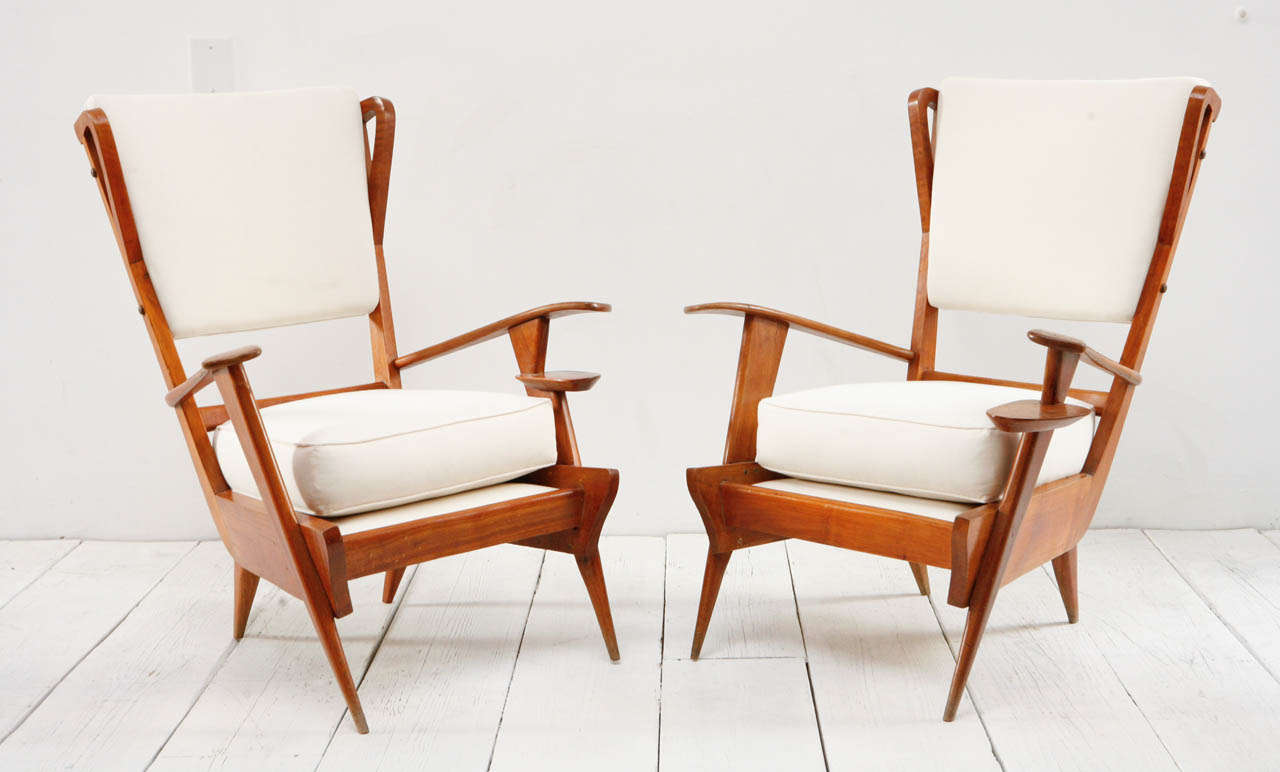 Mid-century lounge chairs with tapered legs and built in cup holders. Newly reupholstered in natural muslin.