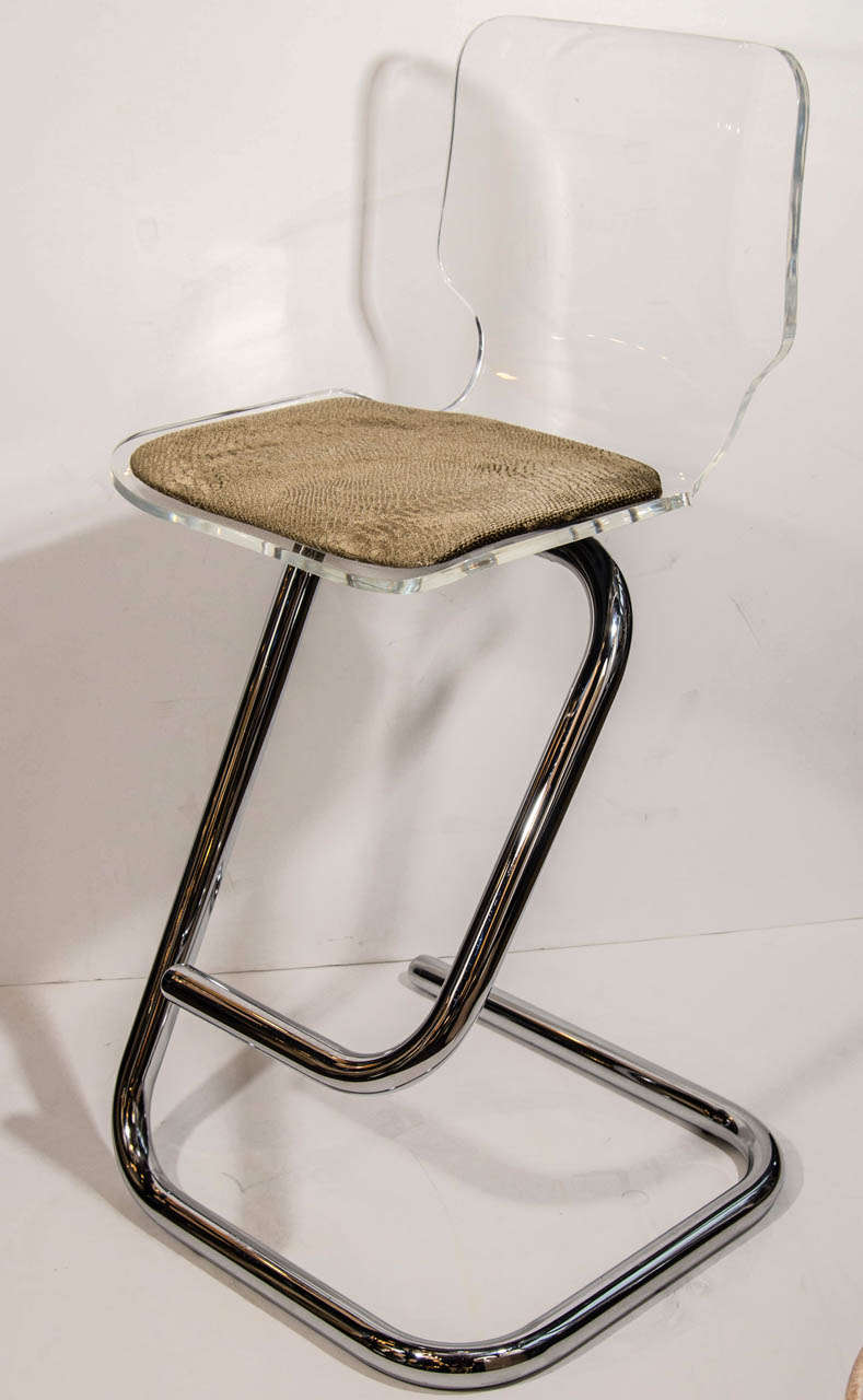 Mid century bar stools with ultra modernist design. Comprised of bent plexiglass seats newly upholstered in a luxe metallic mushroom colored velvet-mohair, with embossed python pattern.  The bar stools have stylized tubular frames in polished chrome