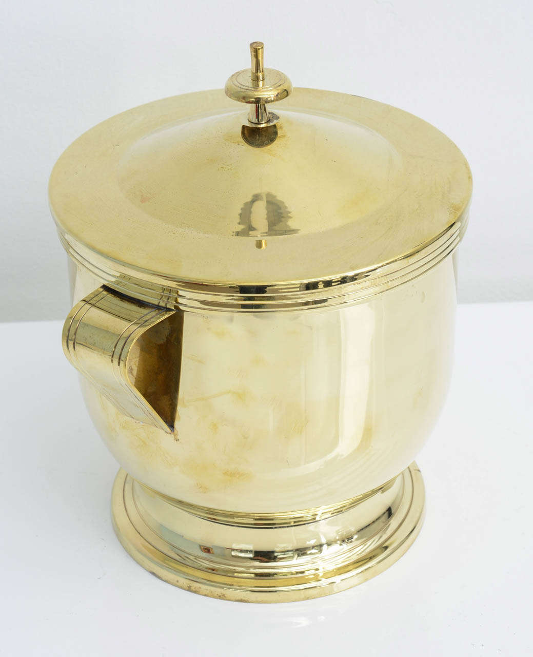 Produced by Dorlyn Silversmiths , designed by Tommi Parzinger this polished brass covered ice bucket . A great addition to your bar or to your Parzinger  collection. Piece shows minor  wear consistant with age and use. Please see photos.