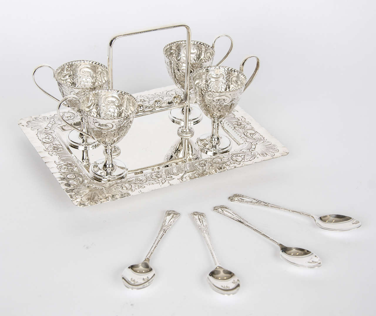 Silver plate egg cruet, with intricate shell pattern on tray. Set comprises of four egg cups and four matching spoons. Circa 1875.

Please enquire about shipping costs due to size and nature of the item.