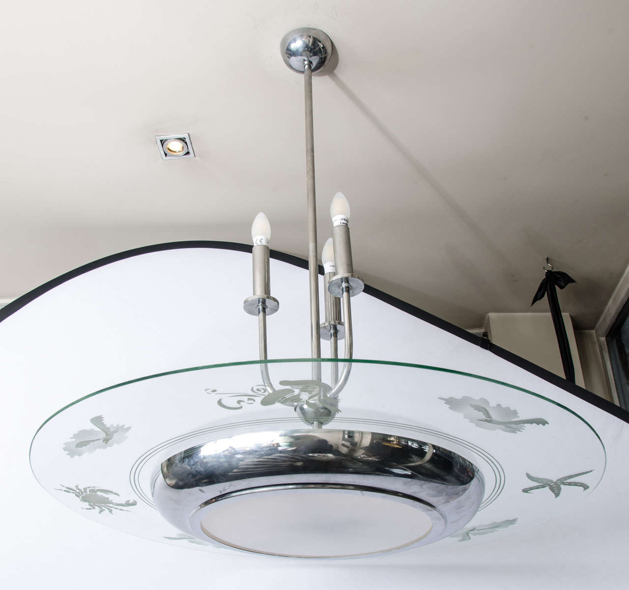 1930s Art Deco chandelier with engraved glass. Italian chandelier in chrome and glass. Three holder electric candelabra plus three bulbs in the base of the dome. The glass is engraved with beautiful sea animals, including crab, octopus and