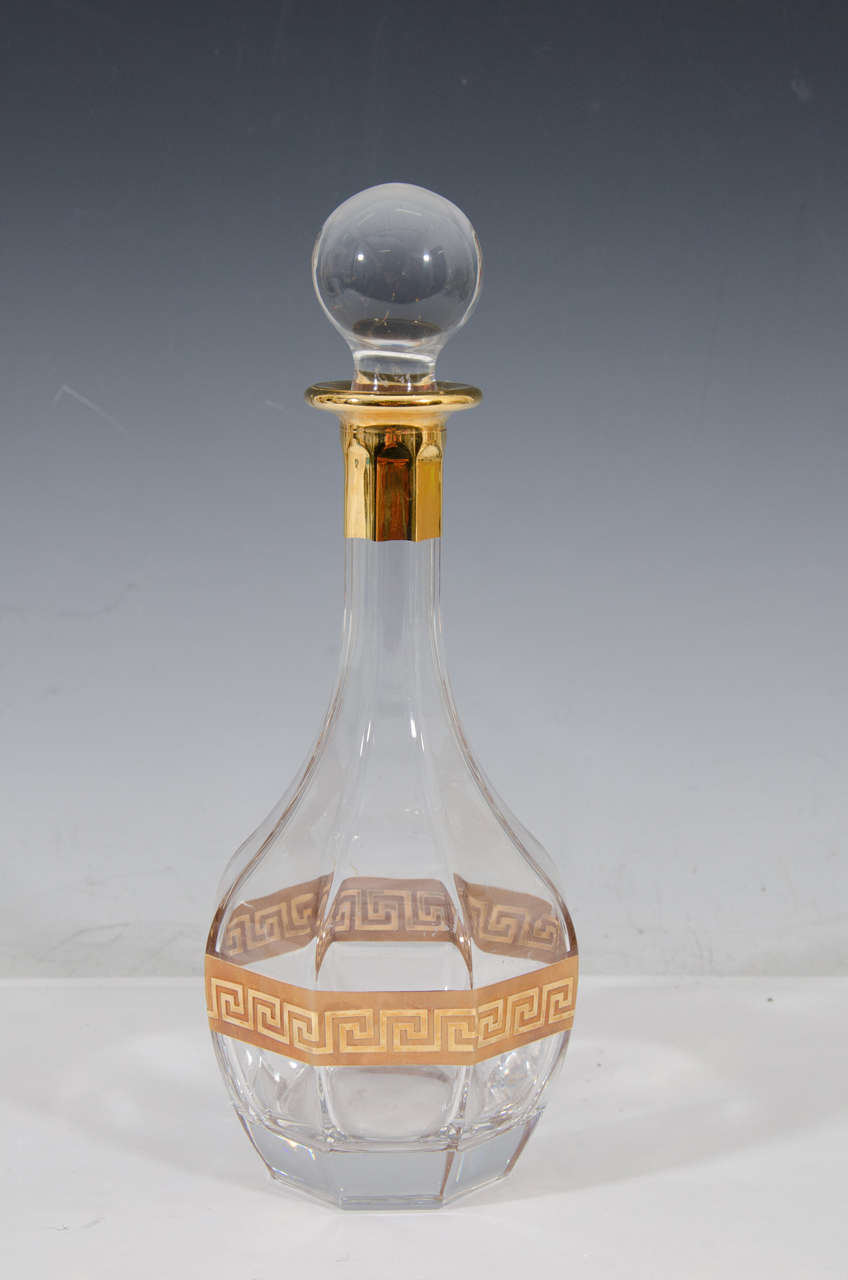 A substantial and beautifully made Italian crystal liquor or spirits decanter in an octagonal shape with a heavy enamel gold 'Greek key' band design, in the Hollywood Regency style, circa Late-20th century, Italy. Gold enamel accent also at top/neck