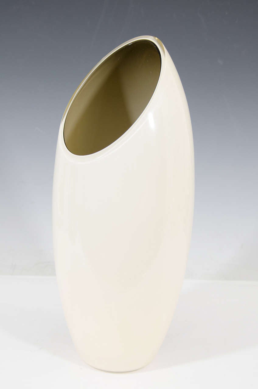 A vintage Italian tall, oval form glass vase, produced midcentury by Seguso, in off-white, with green-gold colored interior. Good condition, with age appropriate wear.