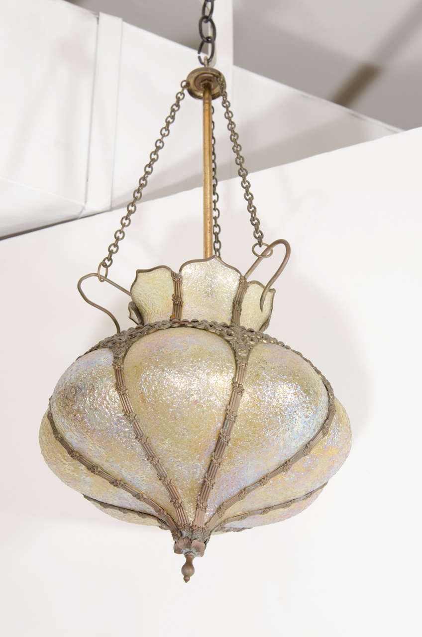 An Art Nouveau hanging lantern in bronze with pale yellow iridescent glass. Good vintage condition with age appropriate wear.