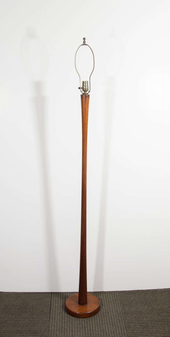 A vintage Danish floor lamp in teak, produced circa 1960s, with weighted circular base. Good vintage condition with age appropriate wear.