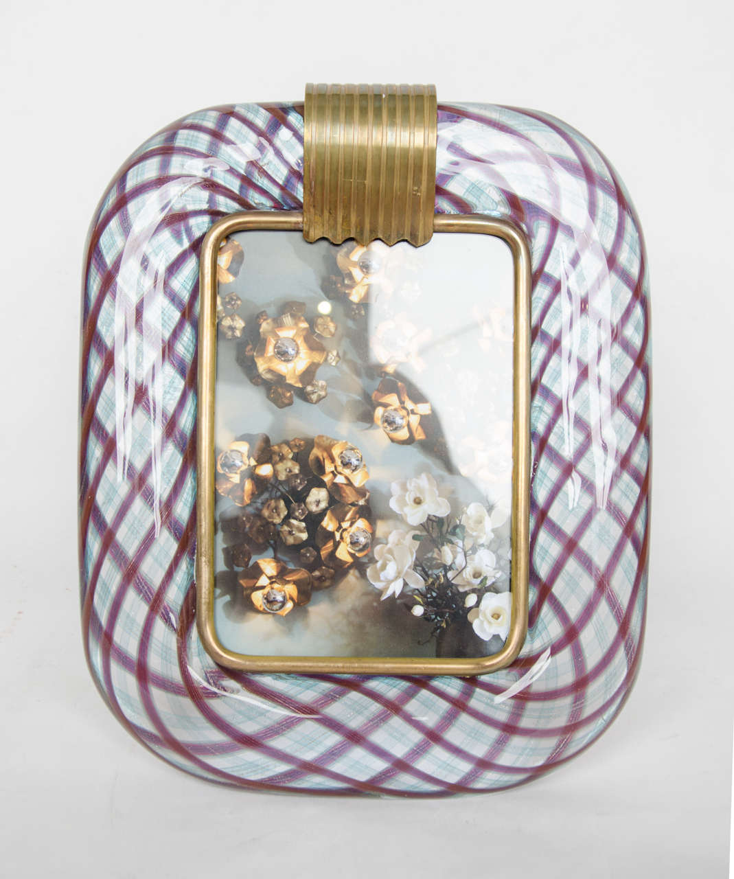 Smooth clear glass patterned with purple and subtle blue design. Brass surround details and support. Signed: for Venini.