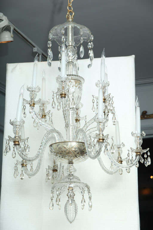 George III Crystal 12 light Chandelier, probably Waterford, the pagoda top with eight drop chains, the central shaft with urn center over two tiers of arms (six high, six low) over center basin, pagoda undertier with elongated acorn drop finial.