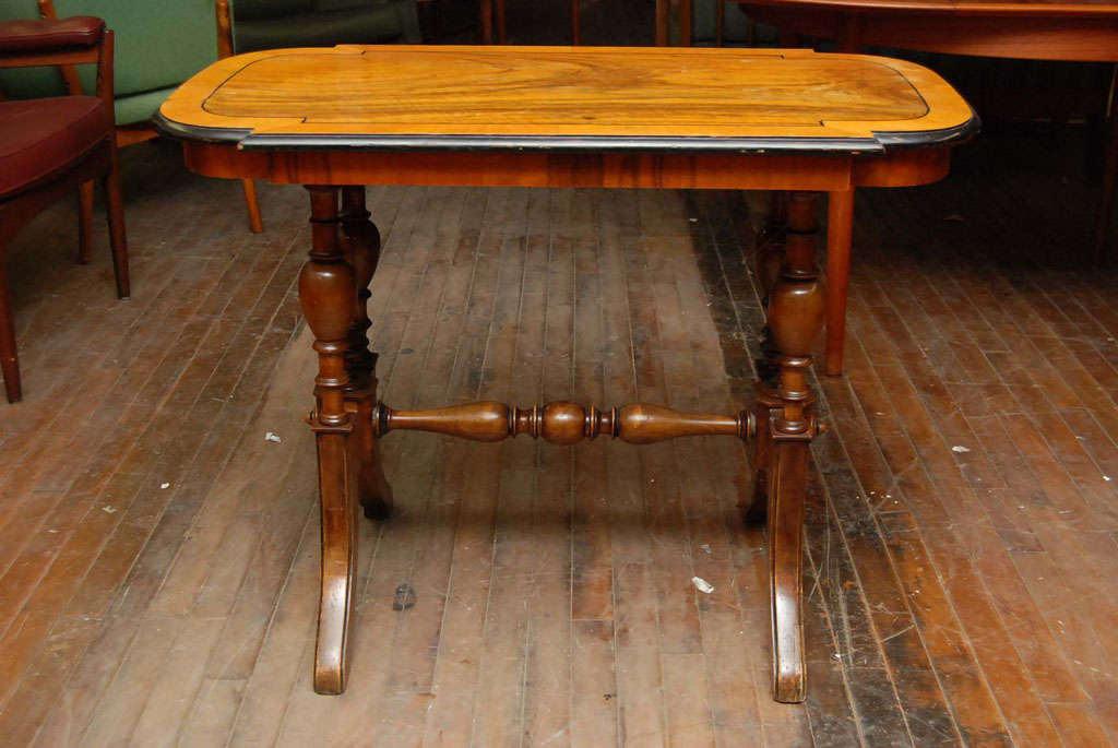 Late 19th century side table in walnut, lozenge shape, with ebonized trim.