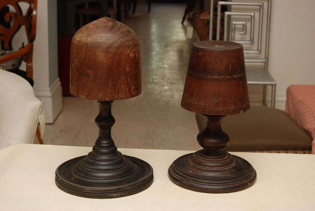 Two Wonderfully Graphic Walnut Hat Blocks from a Milliner's Shop. Late 19th or Early 20th Century.  The refined and finished bases indicate that these blocks were probably used for display