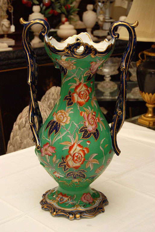 This large decorative vase would be perfect in a niche as it has a dramatic profile but would also look great on a center table since it is fully decorated in the round and looks good from all angles. The bright green glazed body color is further