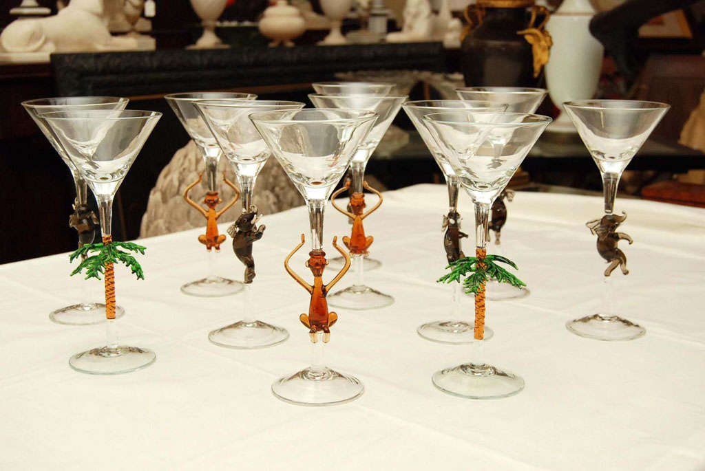 This fun and fine set of 10 hand crafted Murano cocktail glasses has three different kinds of designs. Consisting of animated monkeys, lush palm trees and happy elephants.  Each is made slightly differently as is expected with hand made items and