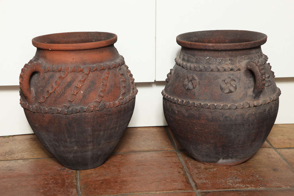 Two Original South of France Terra-Cotta Urns. Very unique and Rare in their design. The piece is original from historical Province of Provence. Vintage 60s 
They benefit from bold everted rims, with well moulded details at the top of the urns and