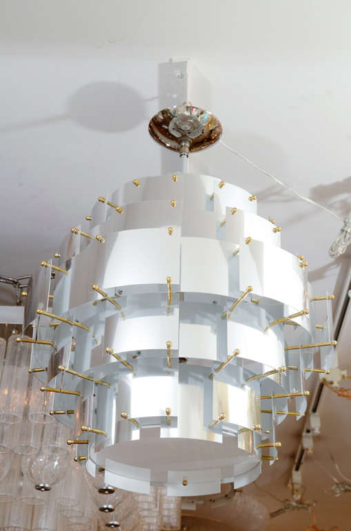 Round stainless steel and lucite ceiling fixture with brass finial details by Sonneman.