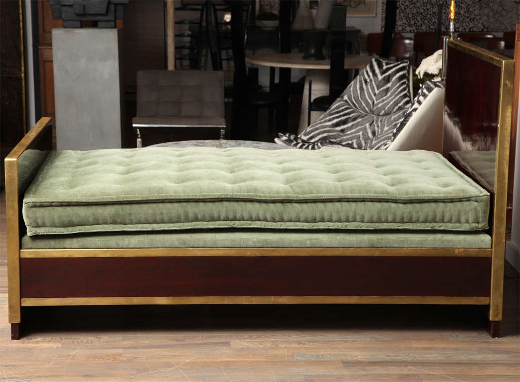 A stunning daybed by Viennese architect Adolf Loos. Lacquered mahogany incased in brass showing the wonderful patina of a piece from Viennese Sesessionism.
The firm mattress is covered in sage green velvet making this best used as a daybed.