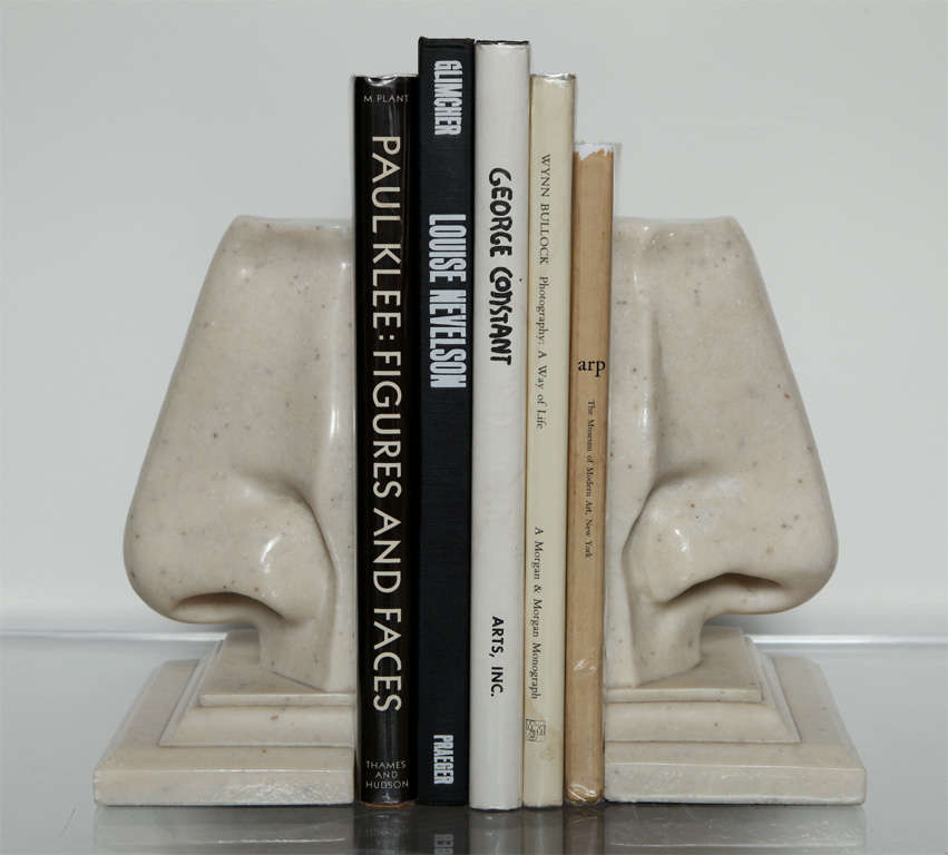 A pair of marble composition nose bookends on bases, very well sculpted and interesting. A great conversation piece.