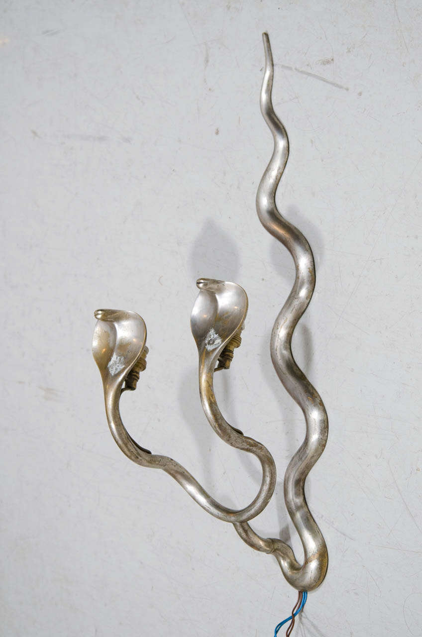 This unusual pair of cobras tempt you to make them your own. They do need to be rewired but what makes them special is the positioning of the cobras. Most cobra sconces the tail hangs down and the head is up top. This pair of cobras are coiled to