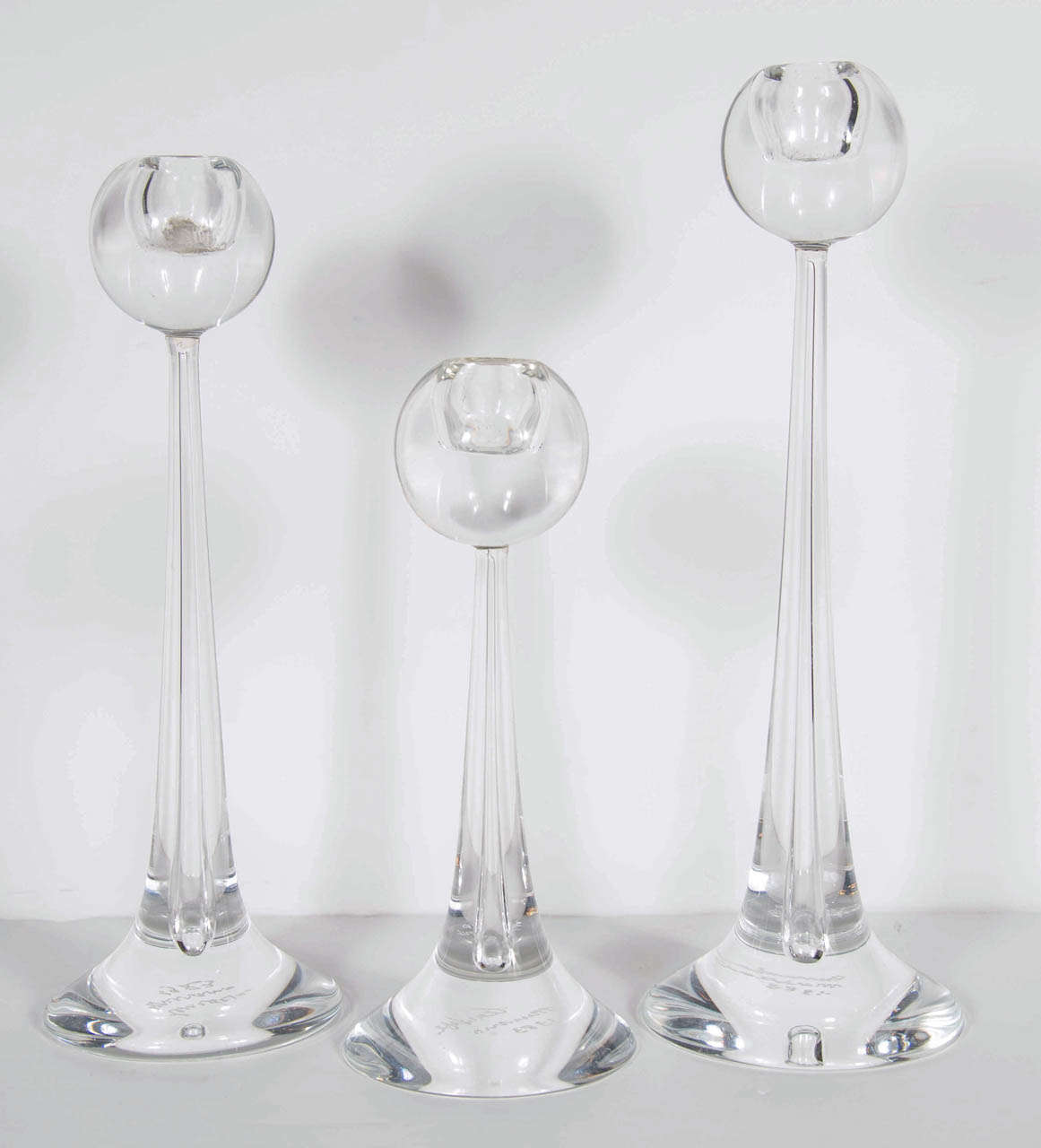These stunning candle stands feature a tapered tear drop design made of hand blown Murano glass by cenedese. These are signed and dated as well. the largest stands 14.5 inches